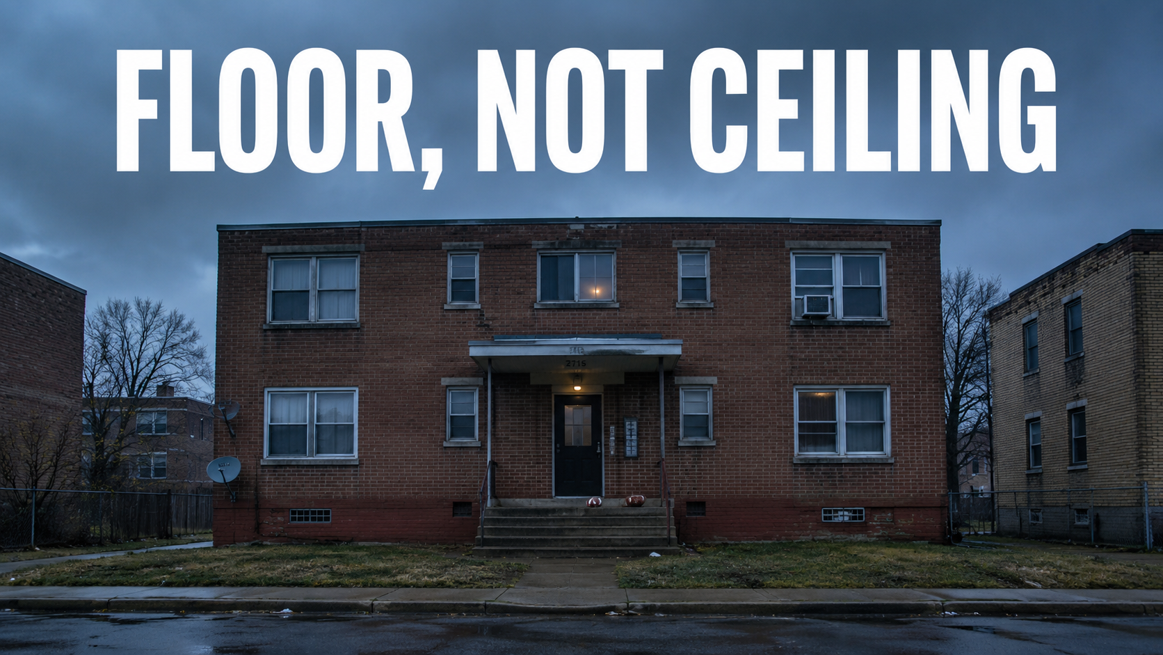 A plain brick apartment building at dusk with a football resting on the porch steps.
